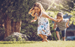 Kids running in Sprinklers