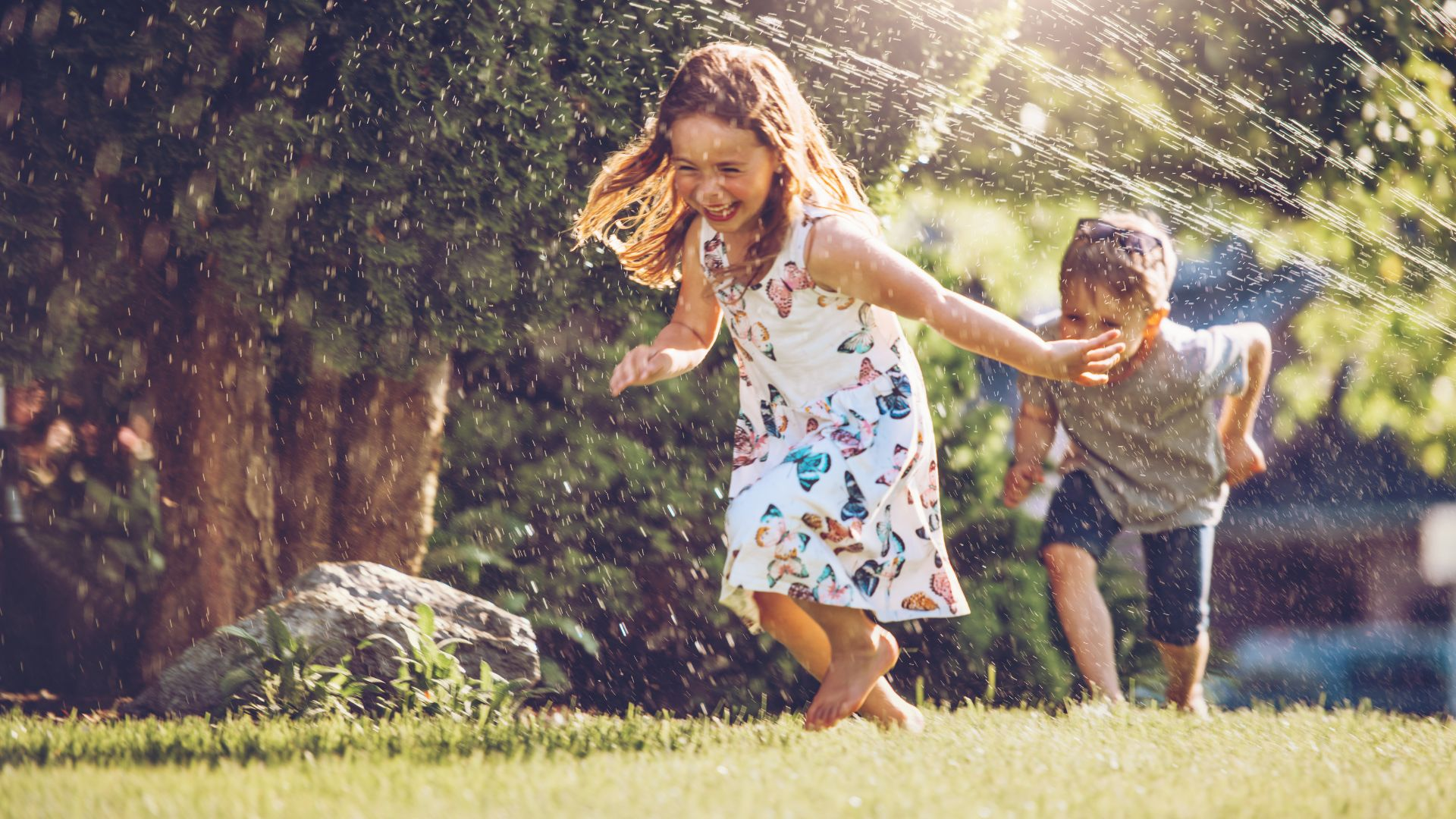 Kids running in Sprinklers